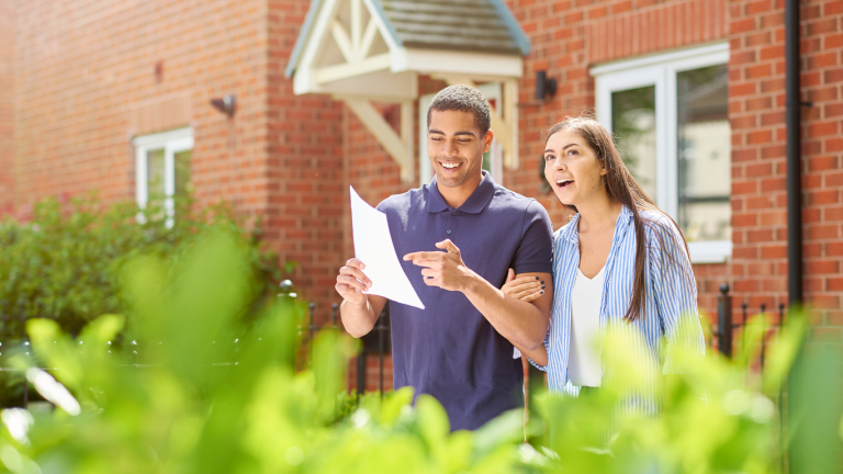 Young first-time buyer couple in Liverpool celebrating getting the keys to their new home